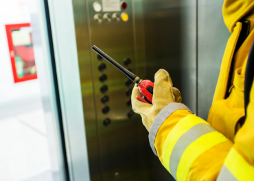 Technician performing routine elevator maintenance